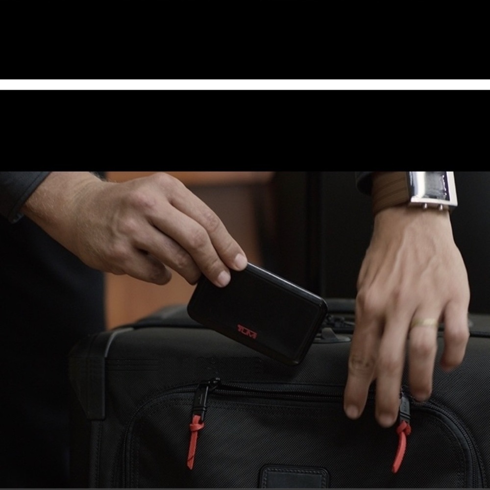 Tumi Global Locator- new, never used protective plastic still on the item!
